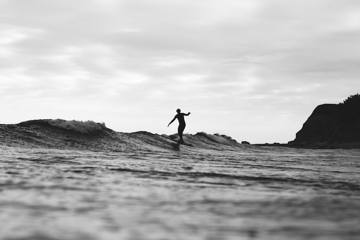 Surfer sliding the wave on a longboard