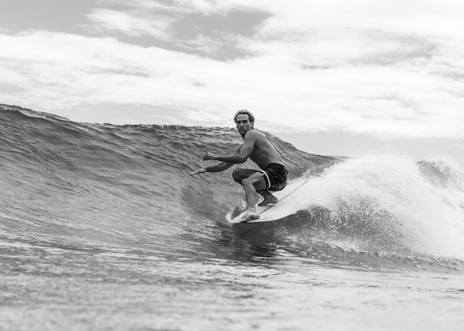 Surfer on the waves surfing with a long board